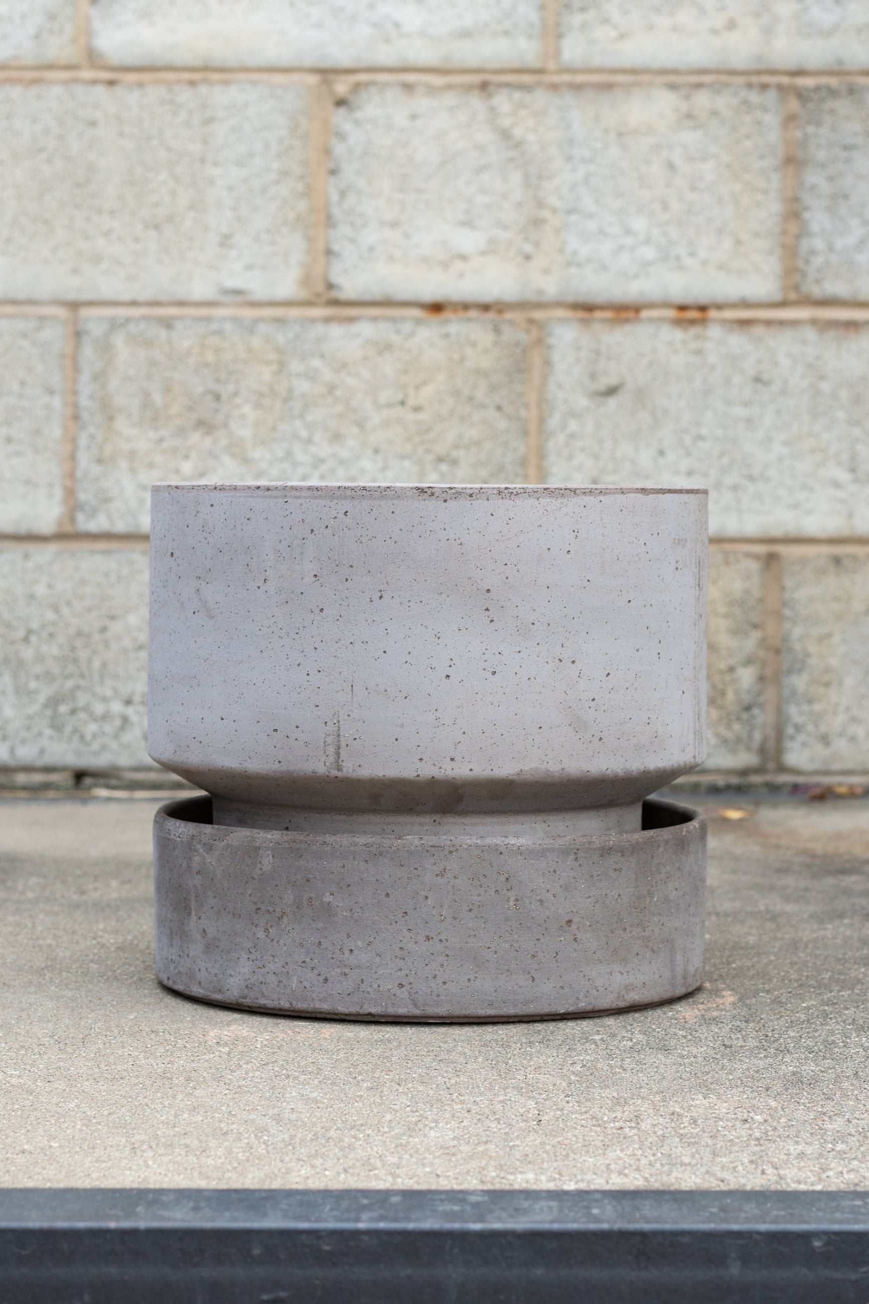 Bergs Potter Hoff Pot & Saucer grey 11.8” in front of concrete brick wall ©Sprout Home