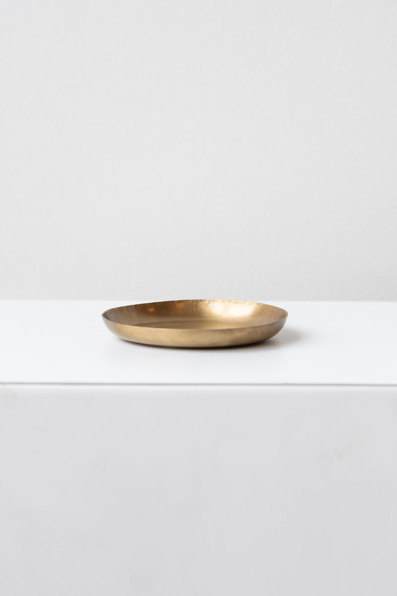 Fog Linen Work small brass round plate on a white surface in a white room