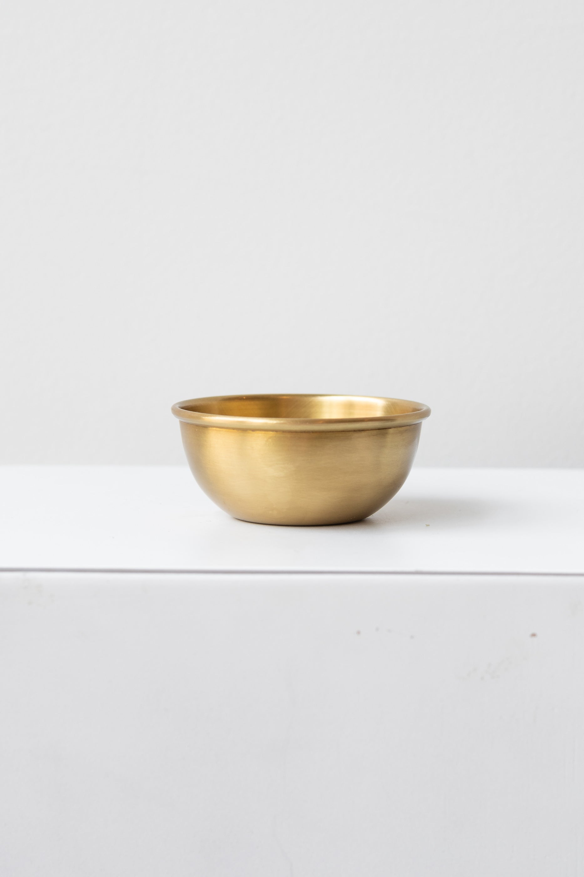 Fog Linen Work small brass bowl on white surface in a white room