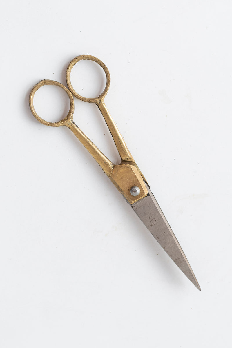 Fog Linen Work brass and steel small scissors on a white surface