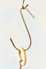 detail of Medium brass hook by Fog Linen in front of white background