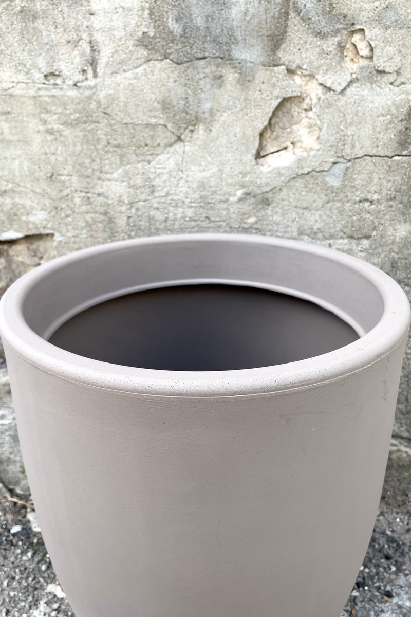 An over-the-lip view of the 16" Porto Planter in Taupe against a concrete backdrop