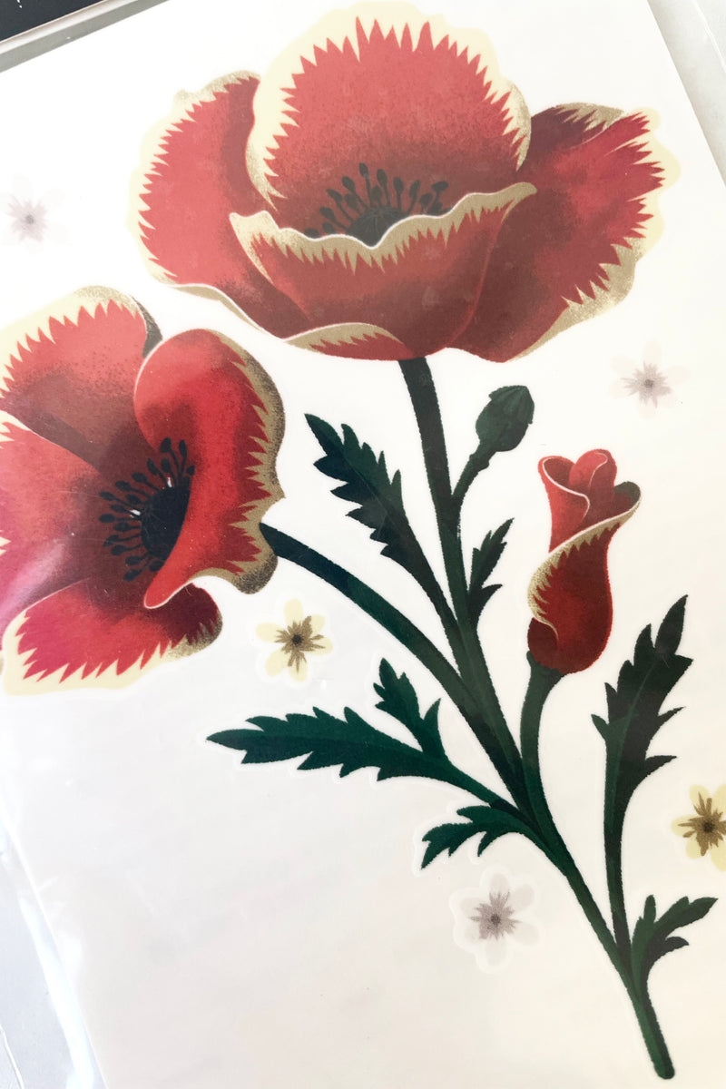 A detailed view of the Poppies Tattoos artwork