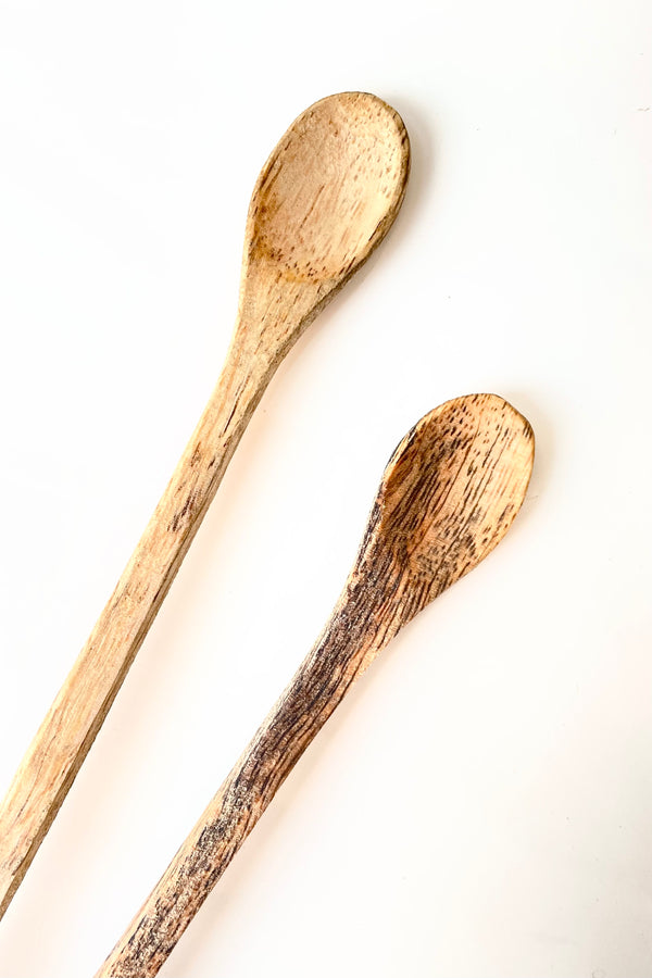 Detail of Fog linen work mango wood muddler spoon held in front of white background