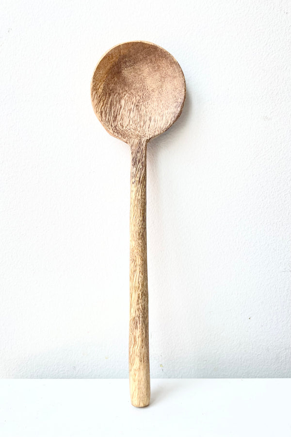 Mango Wood Spoon, 24cm against a white wall