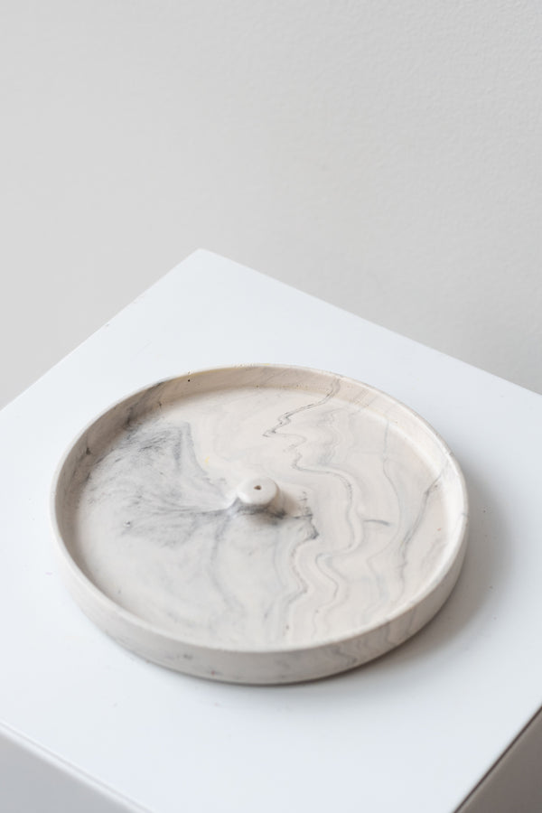The Northern Habitat Incense Tray grey marble on a white surface in a white room