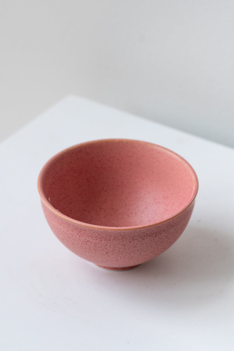 Hot pink ishi teacup by Miya Company Inc sits on a white surface in a white room