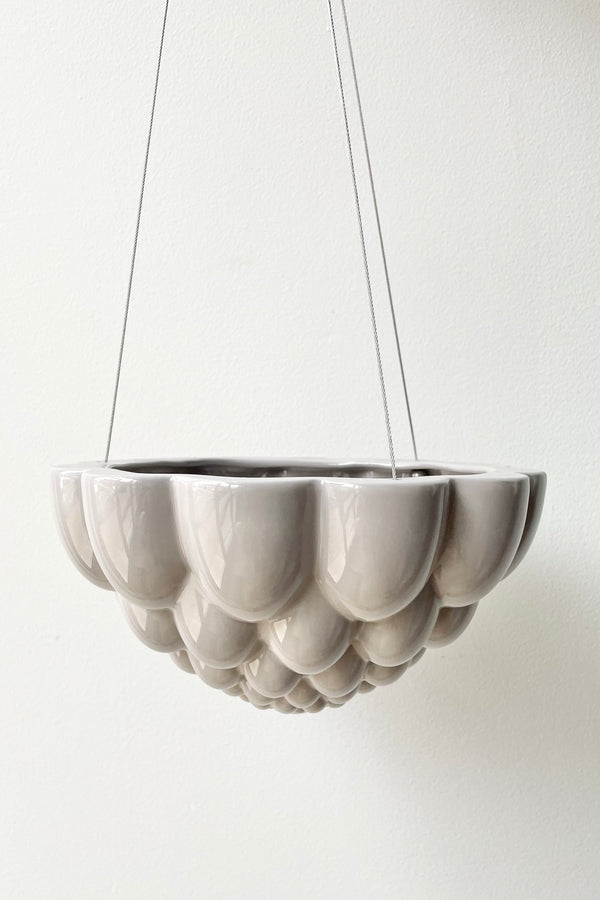 Hanging grey Jelly Planter shown against a white wall. 