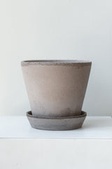Grey 5.5 inch Julie Pot by Bergs Potter on a white surface in a white room