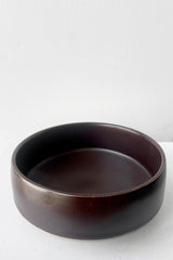 A slightly overhead view of Hagi bowl brown small against white backdrop