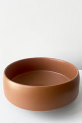 A slightly overhead view of Hagi bowl caramel small against white backdrop