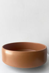 A full frontal view of Hagi bowl caramel medium against white backdrop