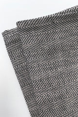 Detail of Fog Linen kitchen cloth herringbone grey held in front of white background