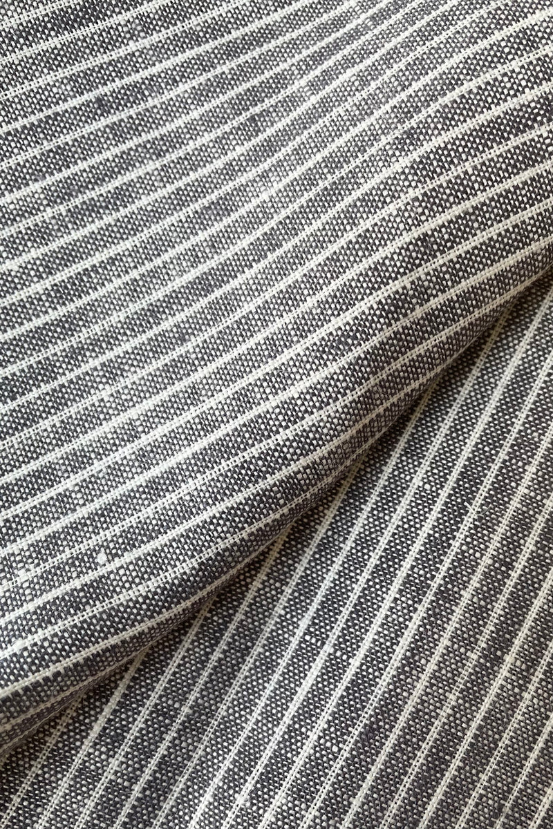 A close-up view of the grey and white linen napkin