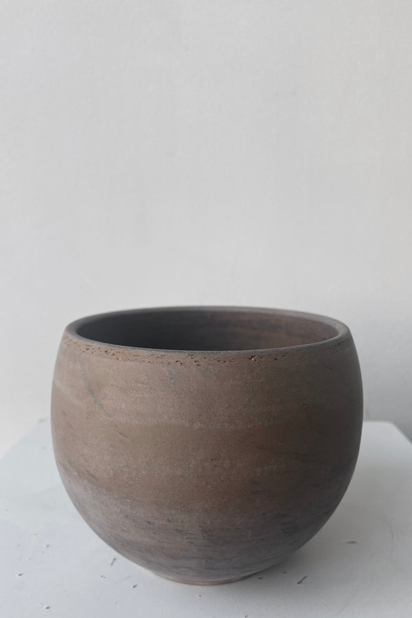 A frontal view of Luna Sphere Pot basalt 4.7" against white backdrop