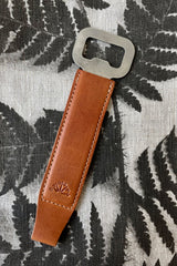 The Manual Bar Blade against a black and white plant print