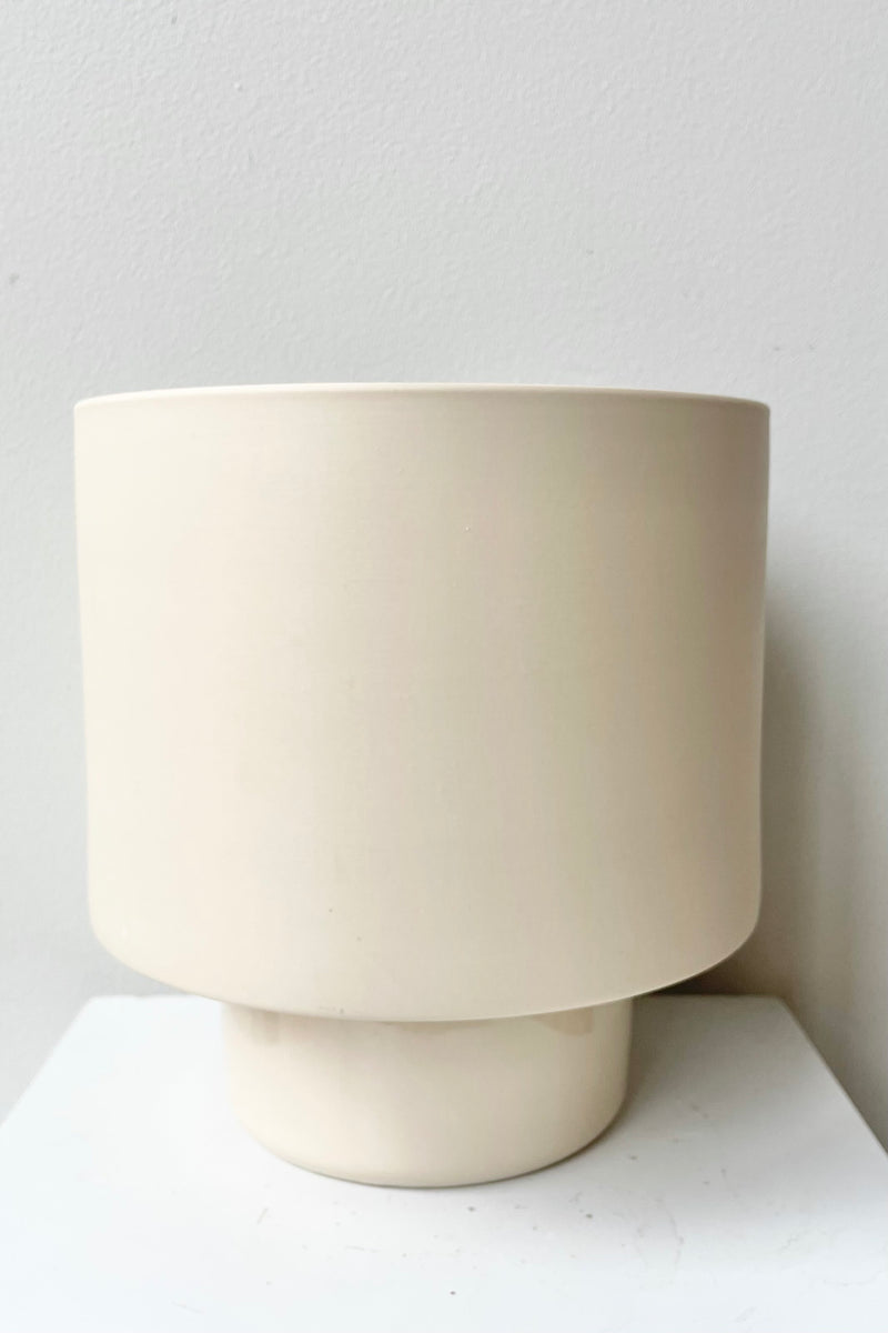 Large clay color Collectors Gro pot against a white wall. 