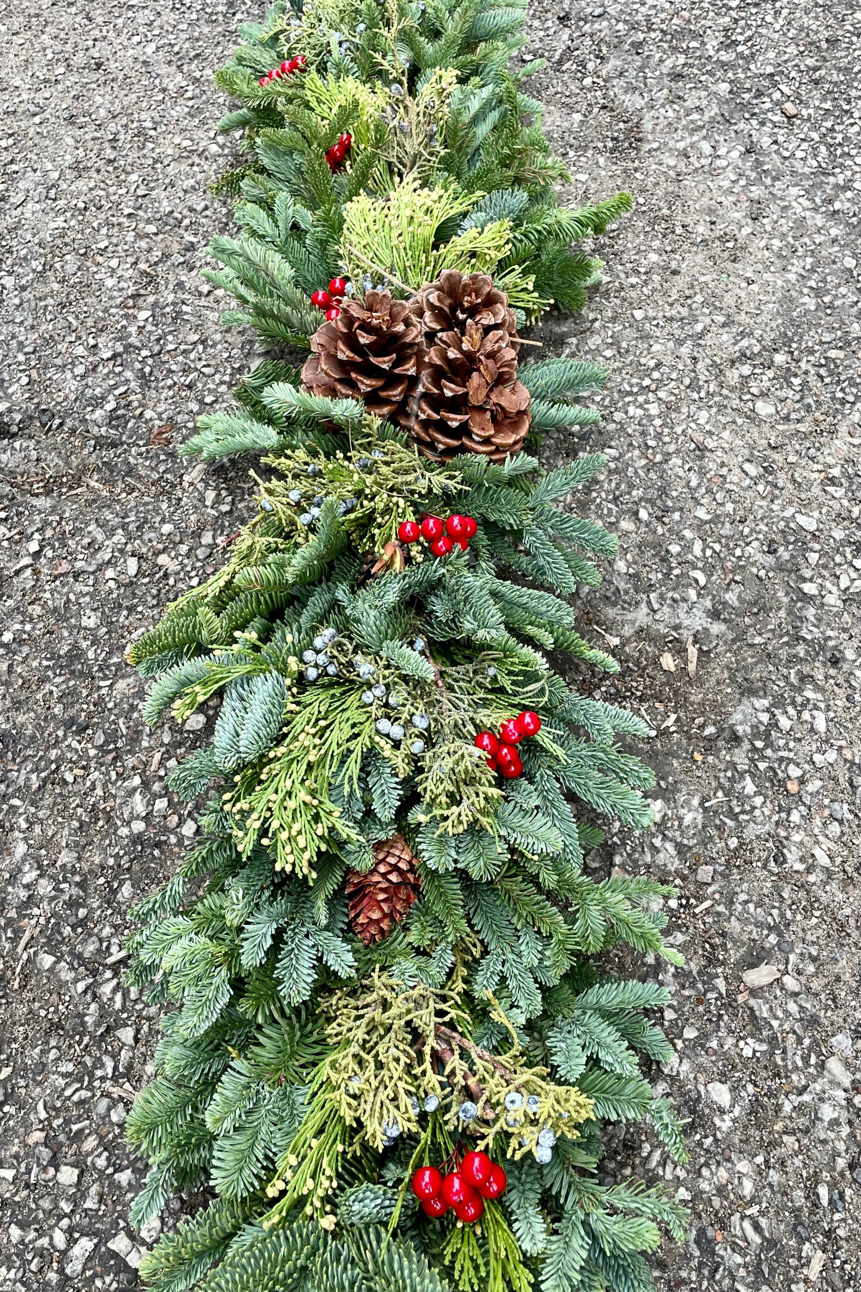 Detail shot of the deluxe swag table runner made of evergreens. ©Sprout Home