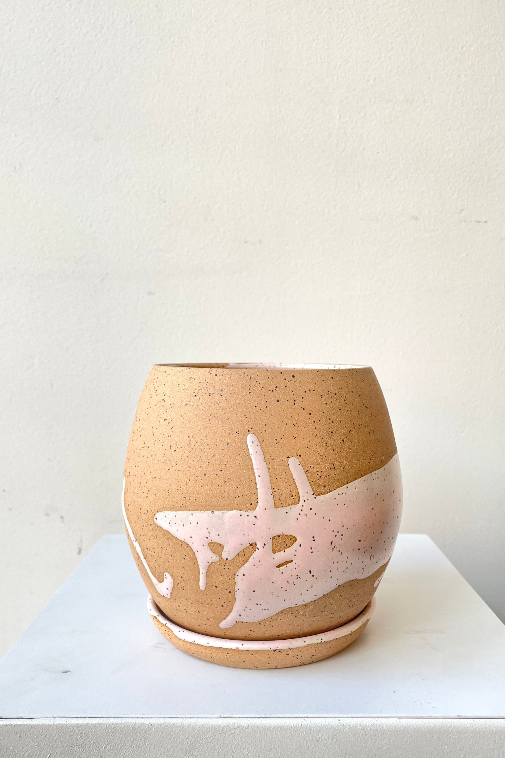 A frontal view of the 4.5" orb pot and saucer in pink against a white backdrop ©Sprout Home