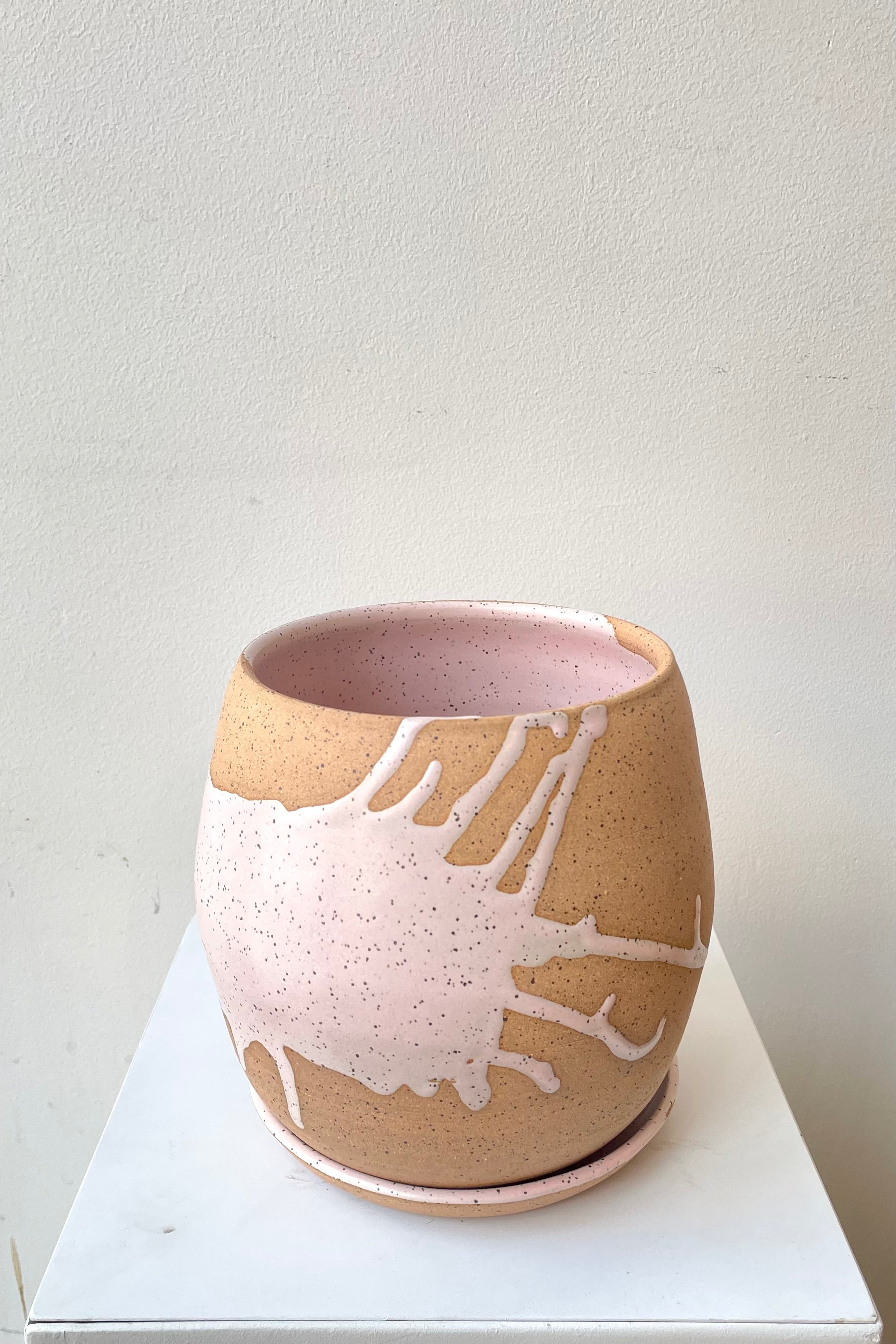 An over-the-lip view of the 6.5" orb pot and saucer in pink against a white backdrop