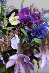 A detailed view of fresh Floral Arrangement Storm by Sprout Home using flowers in purples and blues alongside greenery