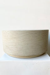 the grey washed Eli pot showing the slight raised bottom against a white wall at Sprout Home.