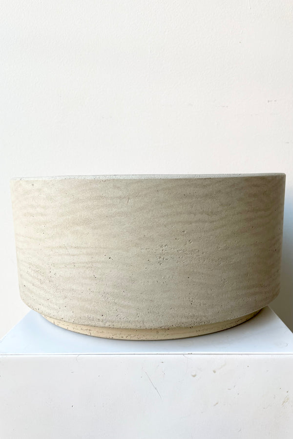 the grey washed Eli pot showing the slight raised bottom against a white wall at Sprout Home.