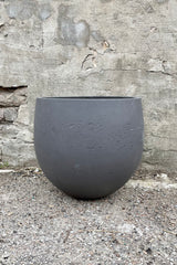 Mini Orb Pot Black Washed Extra Large against a grey wall