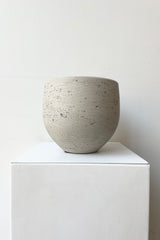Mini Orb Pot Grey Washed Small against a white wall