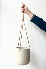 Charlie Hanging Pot grey washed medium against a white wall