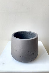 An over-the-lip view of the black washed Patt Pot in small against a white backdrop