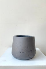 A frontal view of the black washed Patt pot in small against a white backdrop