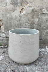 Patt Pot Grey Washed Extra Extra Large against a grey wall