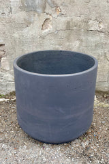 detail of Patt Pot Black Washed Extra Extra Extra Large against a grey wall