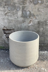 detail of the top of Patt Pot Grey Washed Extra Extra Extra Large against a grey wall