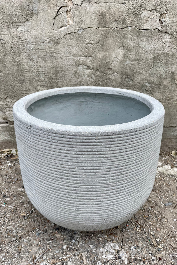 detail of Cody Pot horizontal ridged light grey medium against a grey wall