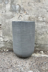 Cody High Pot horizontal ridged dark grey small against a grey wall