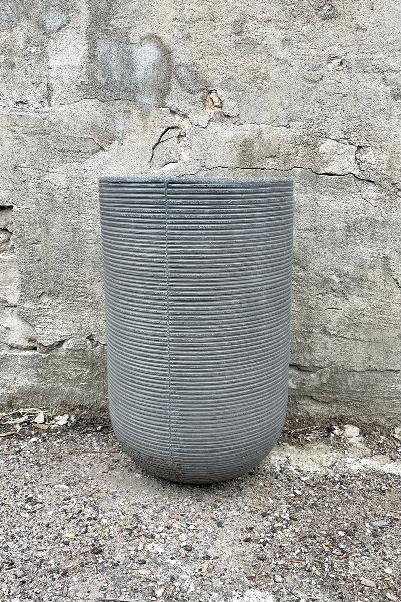 Cody High Pot horizontal ridged dark grey small against a grey wall