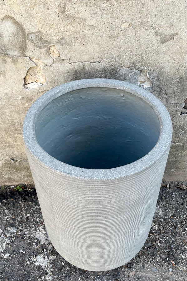 An overhead view of the Cody High Pot horizontal ridged light grey medium against a concrete backdrop