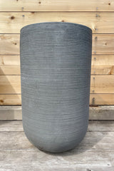 Cody High Pot horizontal ridged dark grey large against a wooden fence