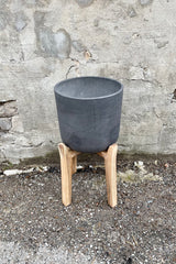 Detail of Charlie Pot & high stand black washed large against a grey wall