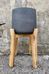 Patt Pot w/ High Feet Black Washed Extra Large against a grey wall