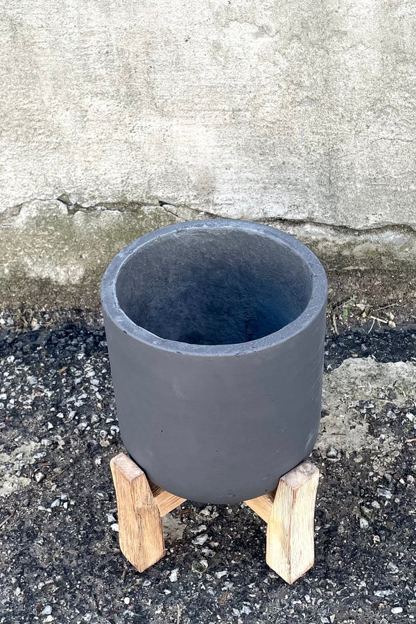 A slight overhead view of Charlie Pot & low stand black washed medium against concrete backdrop