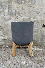 Charlie Pot & low stand black washed extra extra large against a grey wall