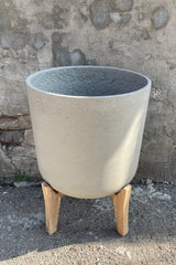 detail of the Charlie Pot & low stand grey washed extra extra large against a grey  wall