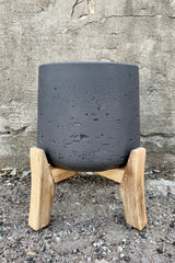 Patt Pot w/ Low Feet Black Washed Extra Large against a grey wall