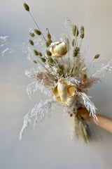 Pillow Talk preserved dried floral arrangement by Sprout Home held in front of white background