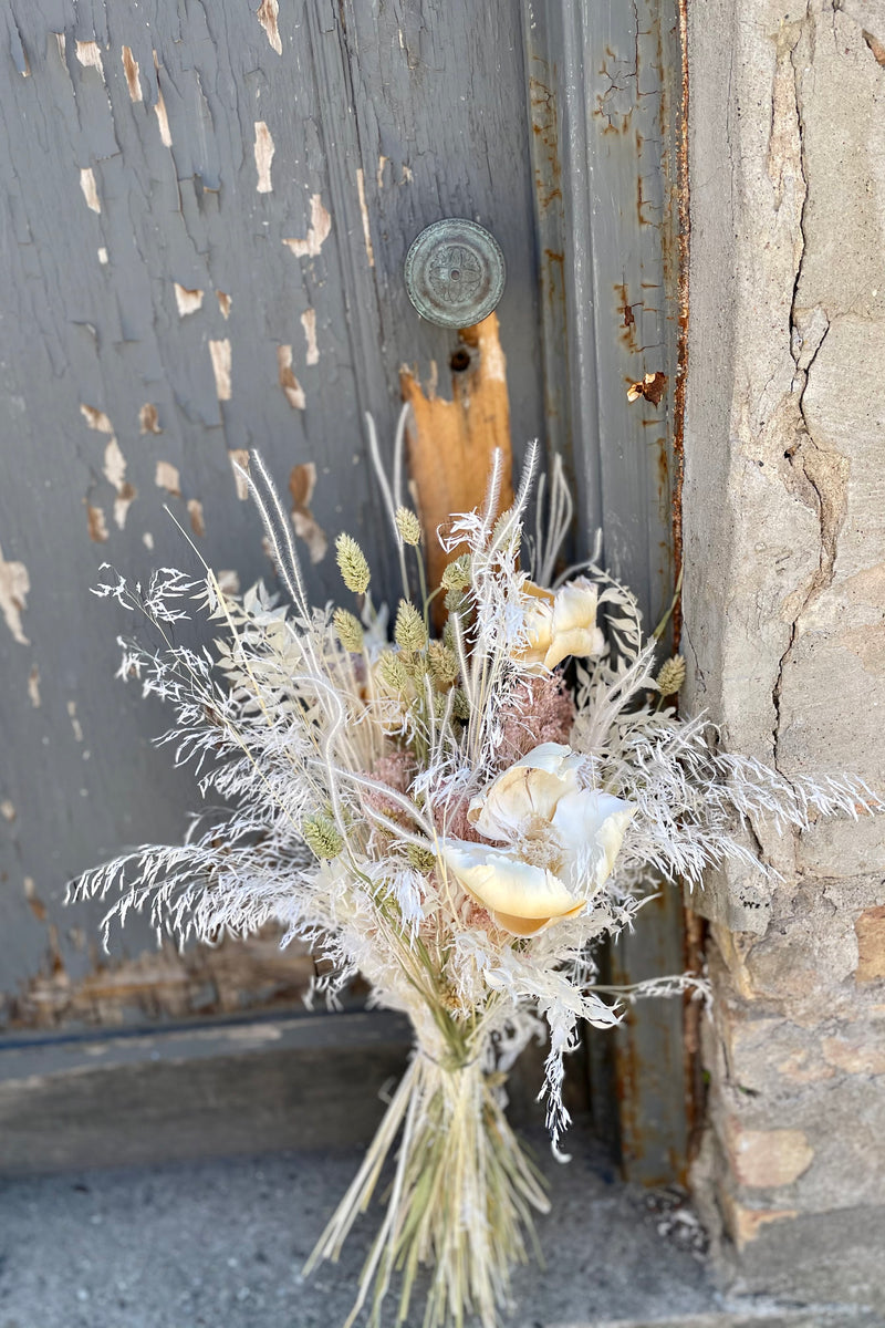 pillow talk preserved arrangement against a grey door. 