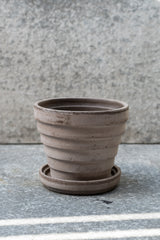 Grey 5.5 inch Planets Pot by Bergs Potter on a grey surface with a grey background
