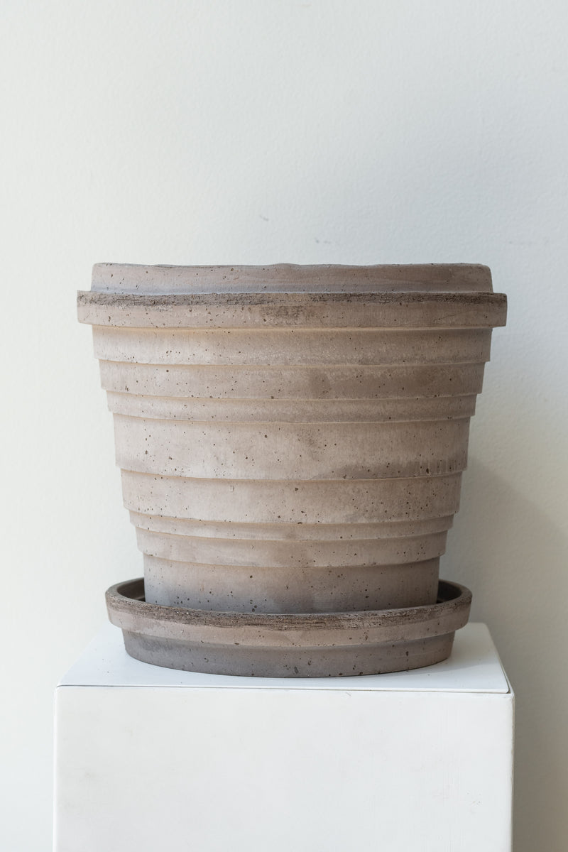 Grey 9.8 inch Planets Pot by Bergs Potter on a white surface in a white room
